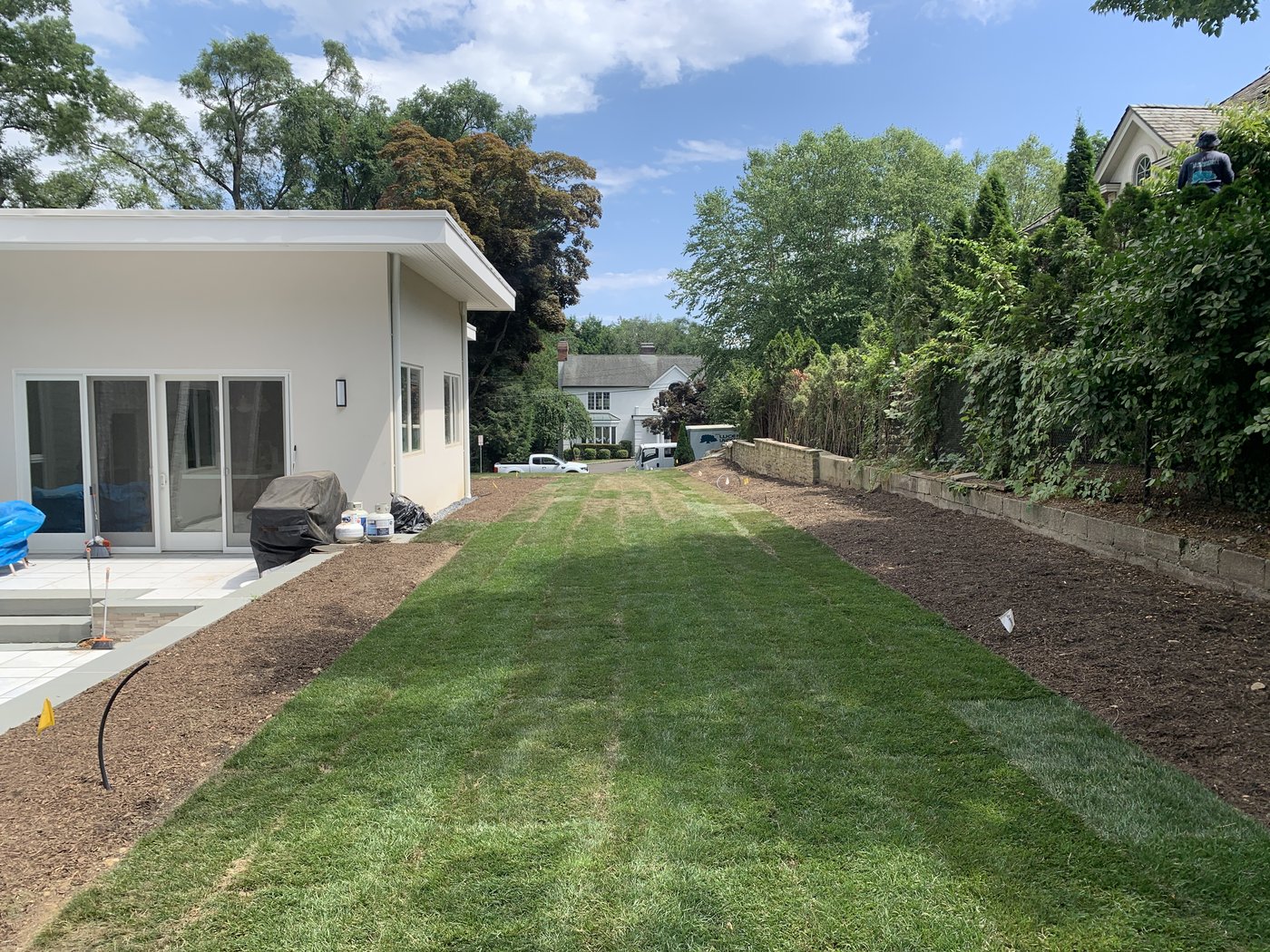 The property before — long view down the side yard, bare earth